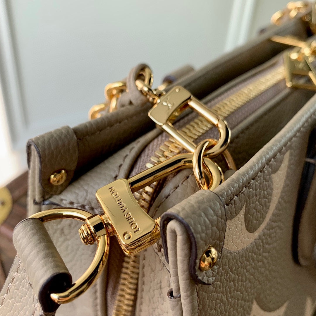 ONTHEGO EAST WEST BAG 25 IN GREEN MONOGRAM EMBOSSED COWHIDE